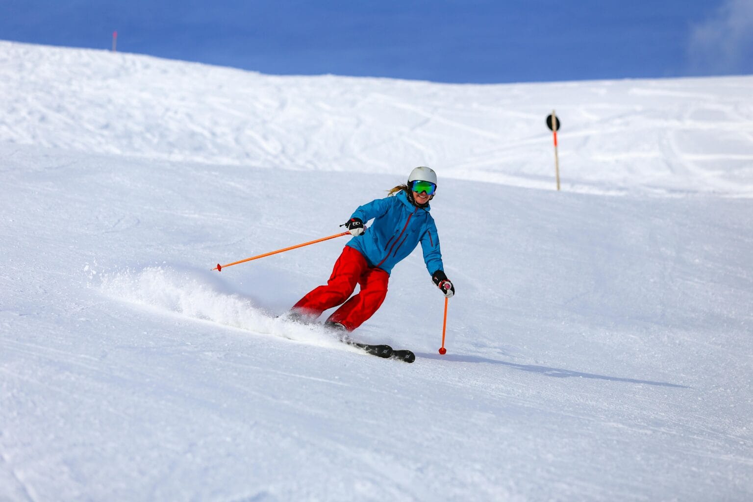 Ski packages - A skier in colorful clothing navigating snowy slopes in Vorarlberg, Austria. Custom ski package planning